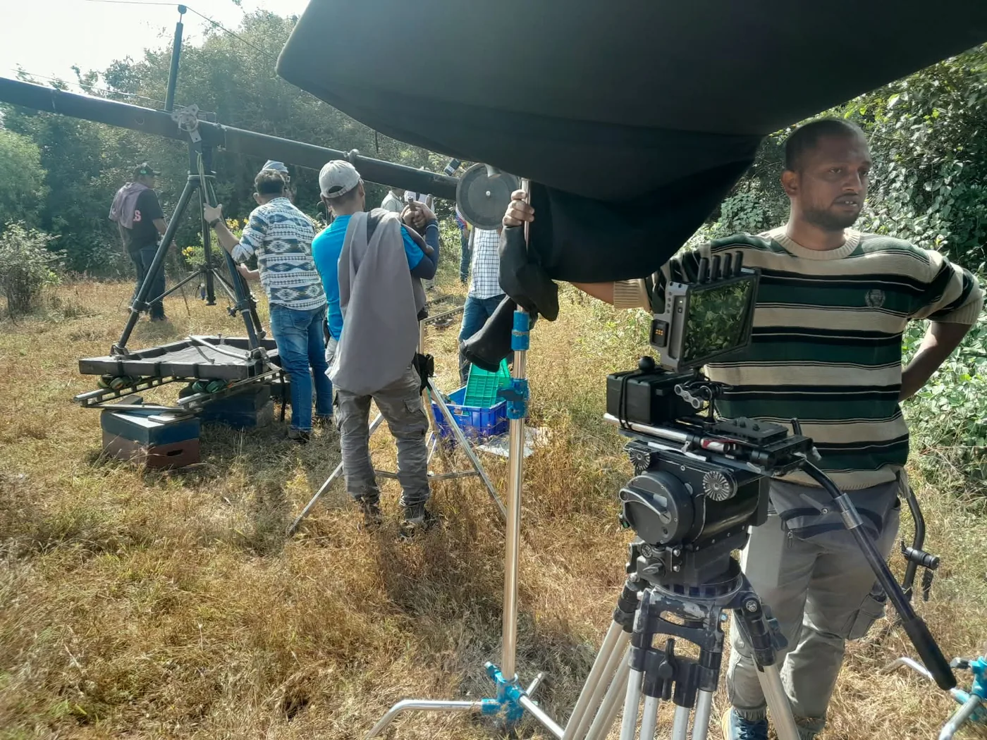 Camera crane rigged in an open field